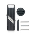 Product image of Global 6.4cm mandolin showing the mandolin vegetable slicer the finger safety guard and the 3 additional toothed blades with a plastic case for different styles of cutting vegetables.