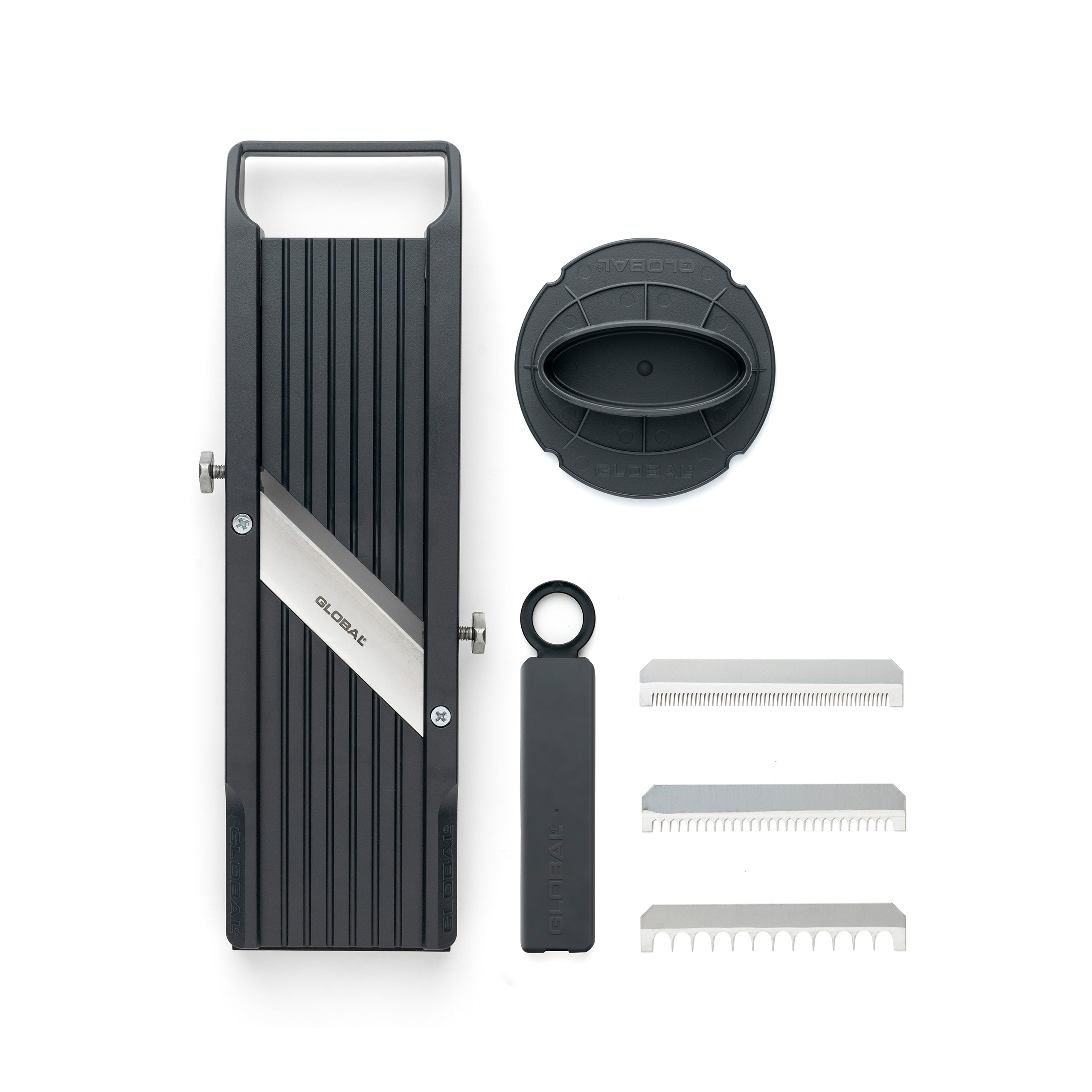 Product image of Global 6.4cm mandolin showing the mandolin vegetable slicer the finger safety guard and the 3 additional toothed blades with a plastic case for different styles of cutting vegetables.