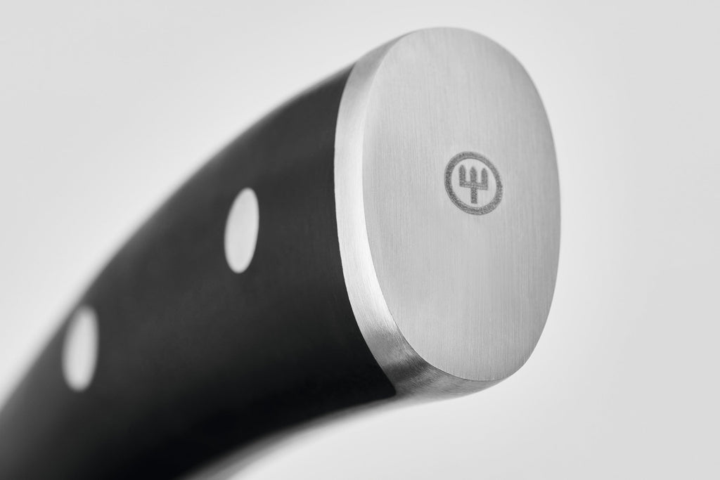 Close-up of the rounded stainless steel butt end of the Classic Ikon Asian Utility Knife 12 cm | 4 1/2 inch handle featuring the Wüsthof logo and three metal rivets.